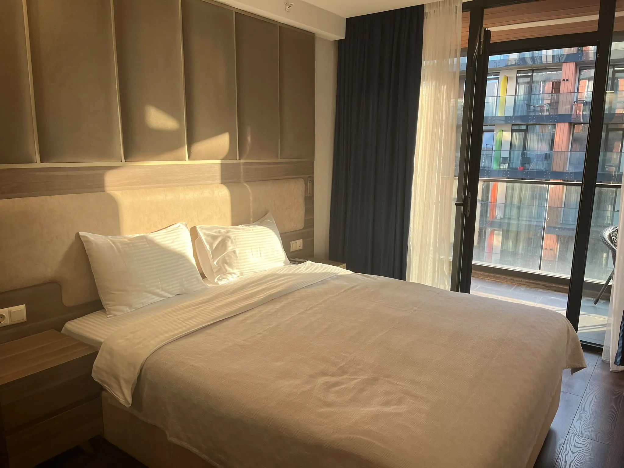 A furnished Batumi bedroom with a balcony over the sea